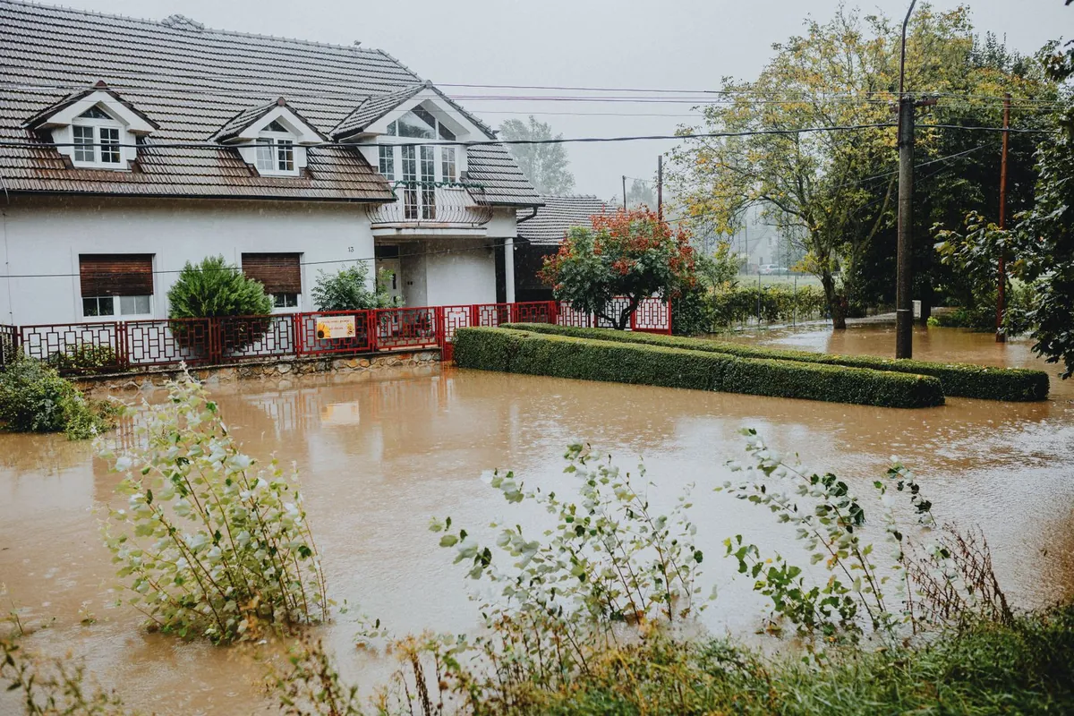 A suburban home surrounded by floodwater after a storm